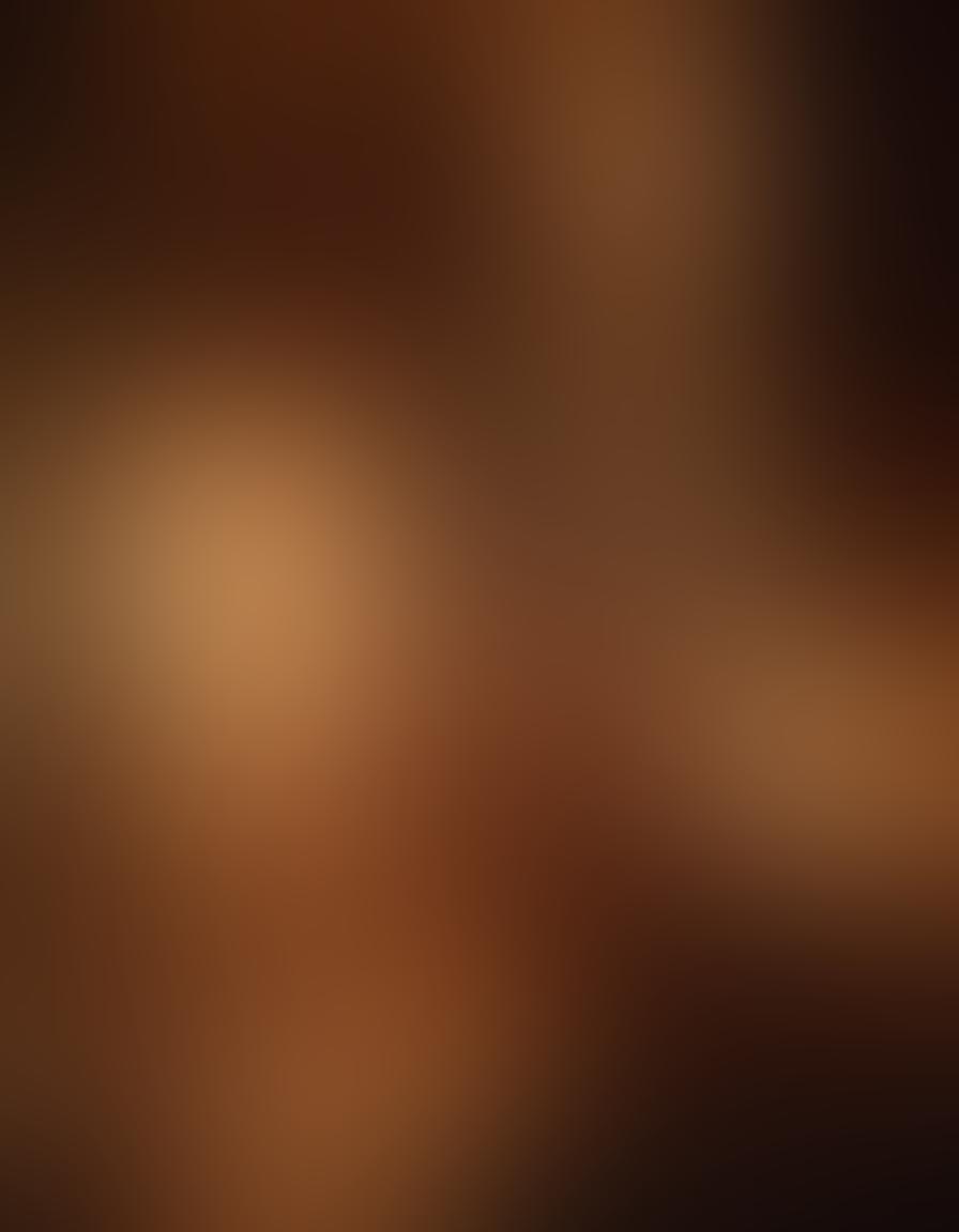 A romantic and sensual scene featuring a couple exploring various forms of erotic media, surrounded by artistic representations of love and intimacy, dimly lit with soft candlelight creating an intimate atmosphere. Include elements such as books, films, and art, symbolizing personal growth and relationship insights. Soft focus, dreamy ambiance. super-realistic. warm colors. intimate atmosphere.